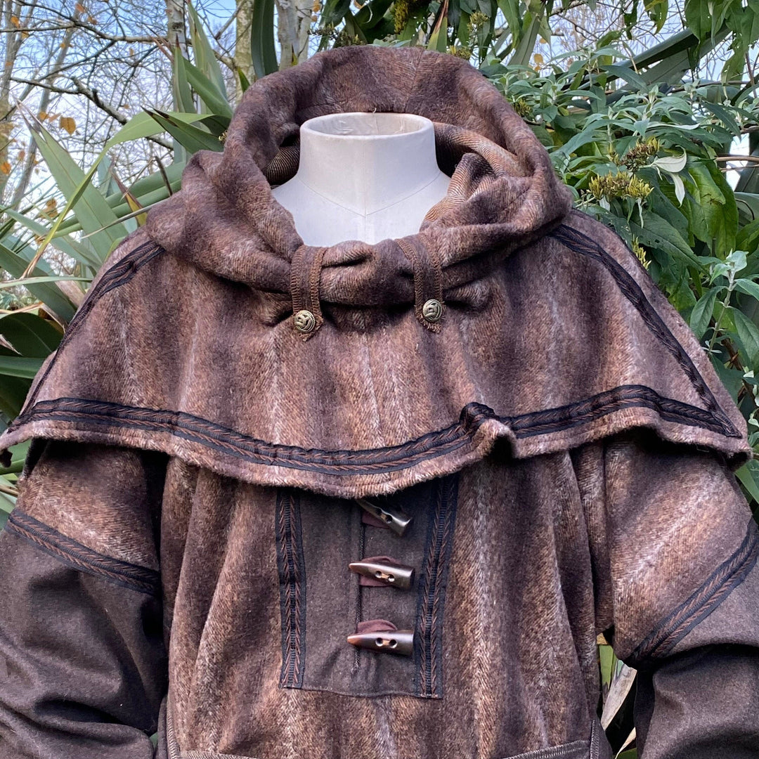 Brown wool LARP snood hood with toggle details, leafy backdrop.