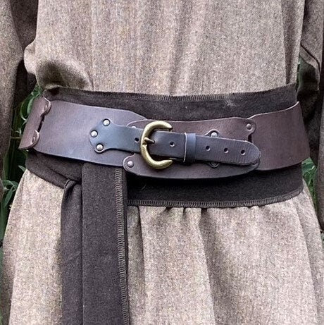 Brown LARP belt on tunic, brass buckle, medieval costume close-up.