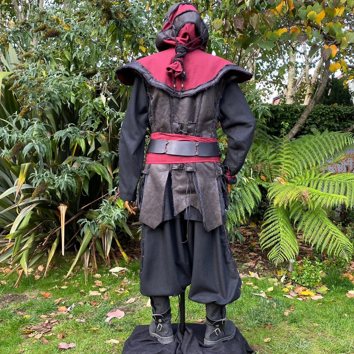 Medieval LARP outfit back view, featuring a red and black hood, waistcoat, shirt, belt and sash.