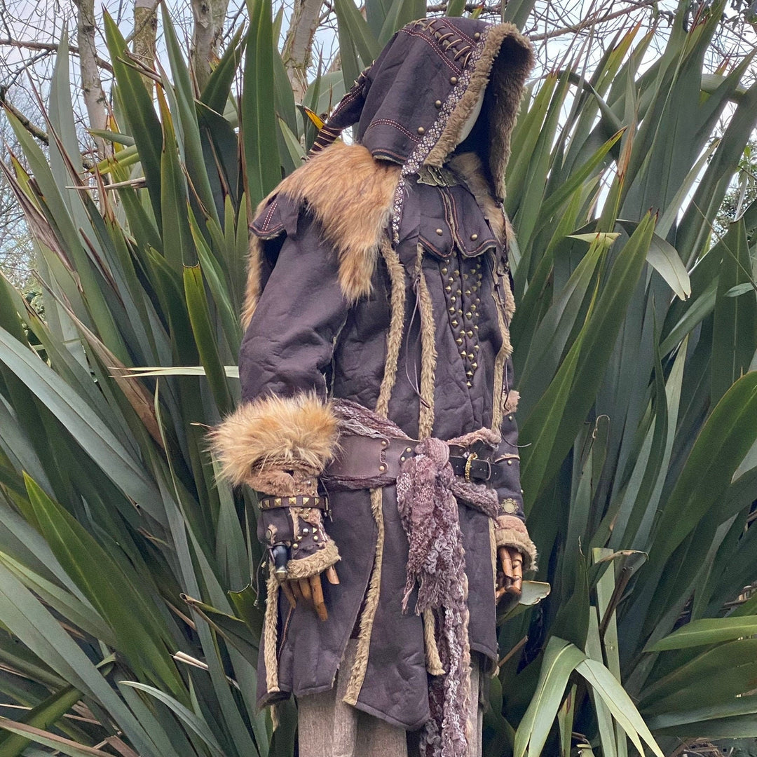 Side view of hooded medieval LARP set with fur trims and detailed vambraces.