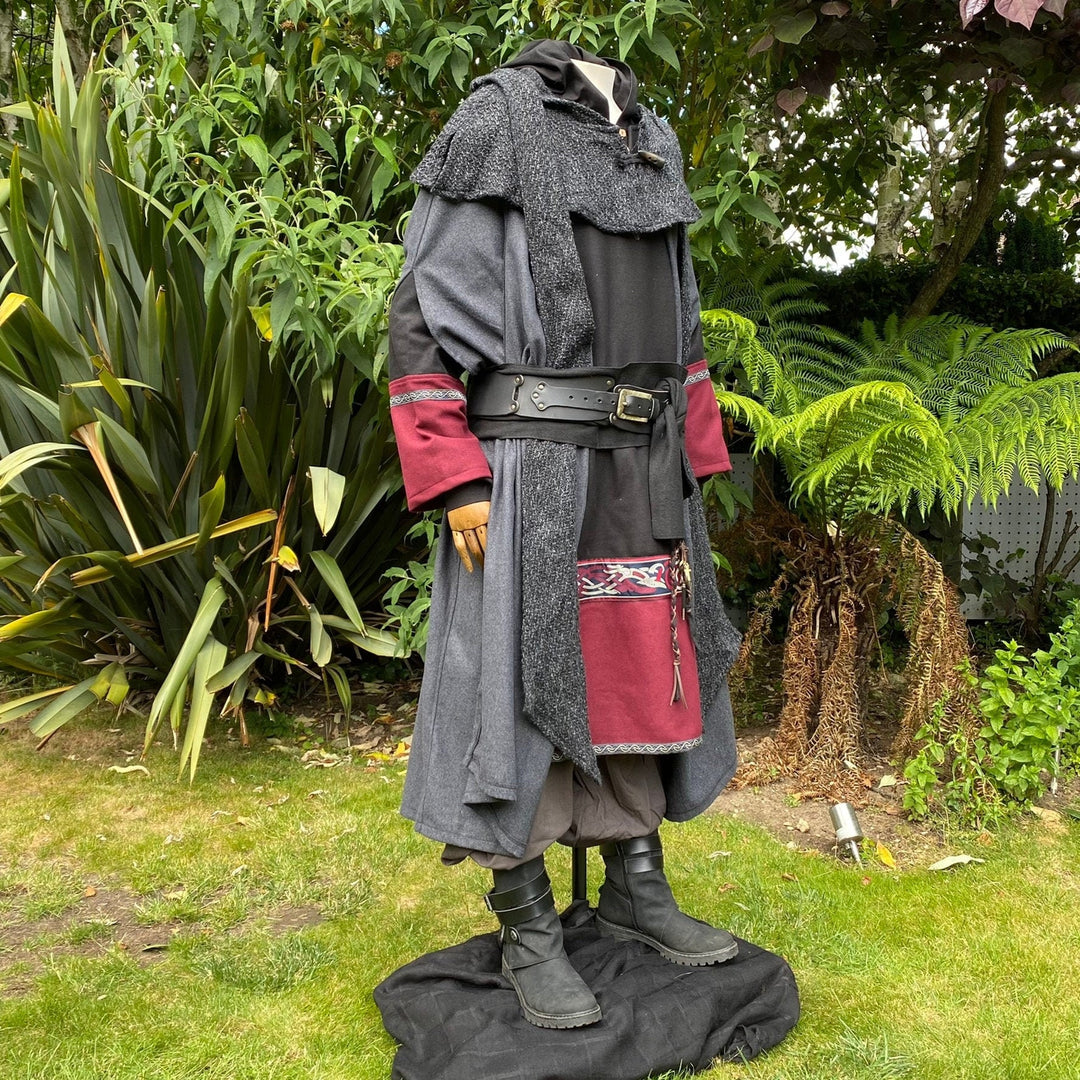 Dark mage LARP set outdoors; side view with red-trimmed sleeves and layered cloak.