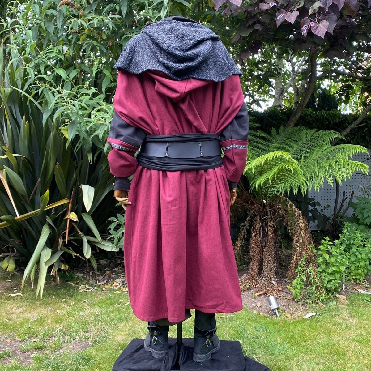 Back view of medieval LARP outfit with red cloak and black belt.