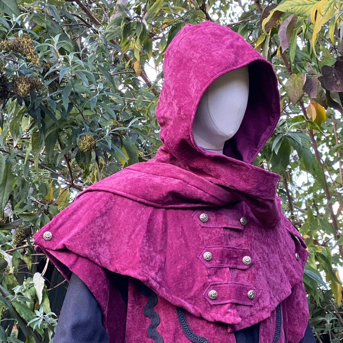 Mannequin with medieval red faux suede hood, button detail.