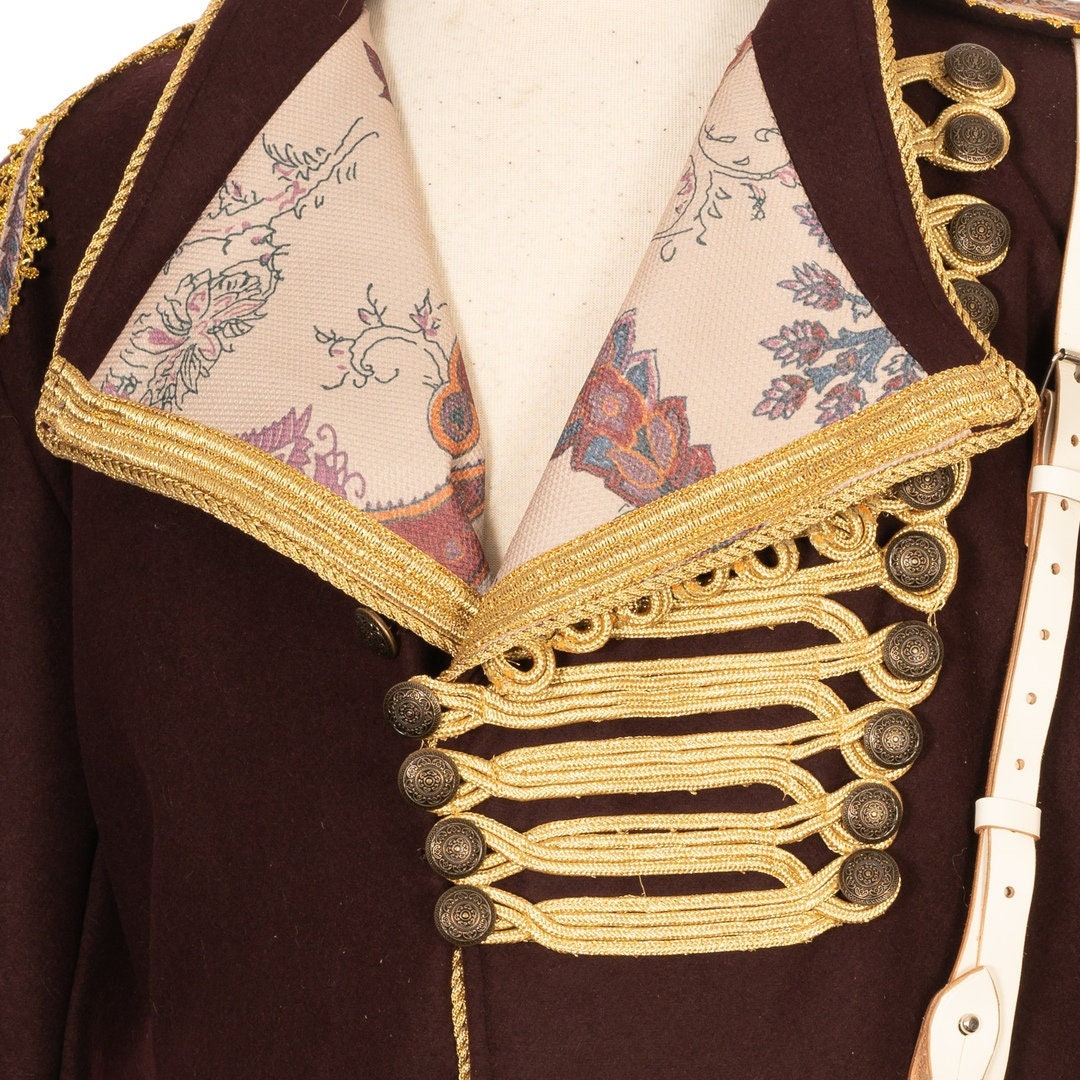 Interior view of dark red wool pirate coat showing brocade lining and craftsmanship.