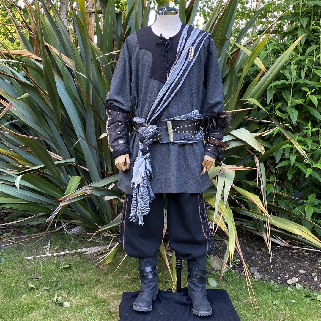 LARP medieval rogue attire on mannequin, garden backdrop, detailed vambraces.