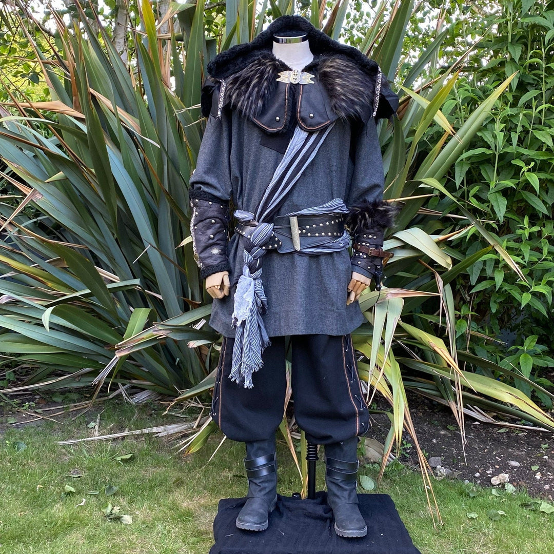 LARP medieval rogue outfit with fur cape, vambraces, and draped sash.