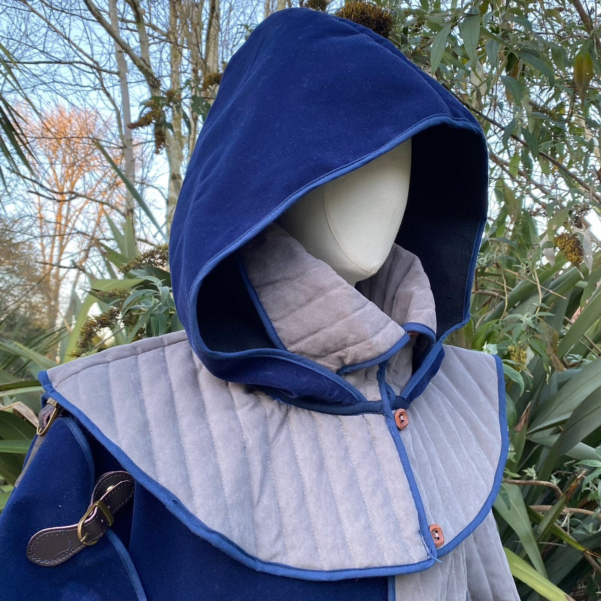 Azure LARP warrior set with blue hood and quilted tunic, side view.