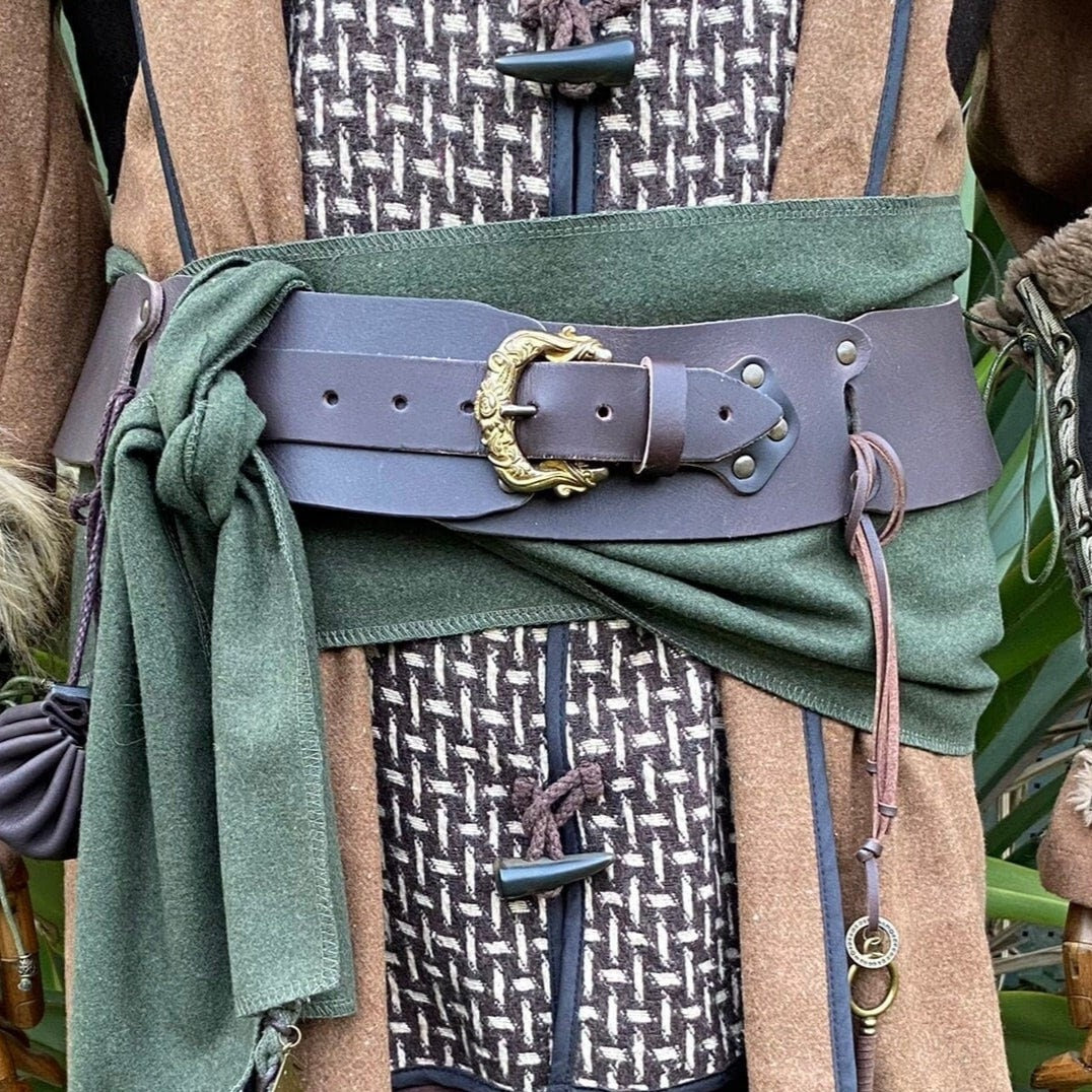 Brown LARP belt with ornate buckle over green and textured fabric layers.