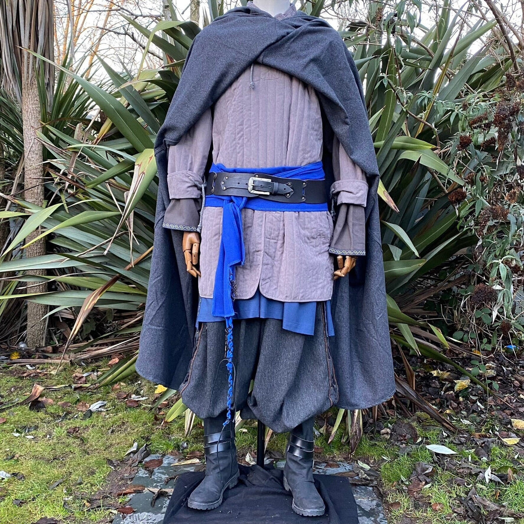 LARP medieval costume with blue sash, black boots.