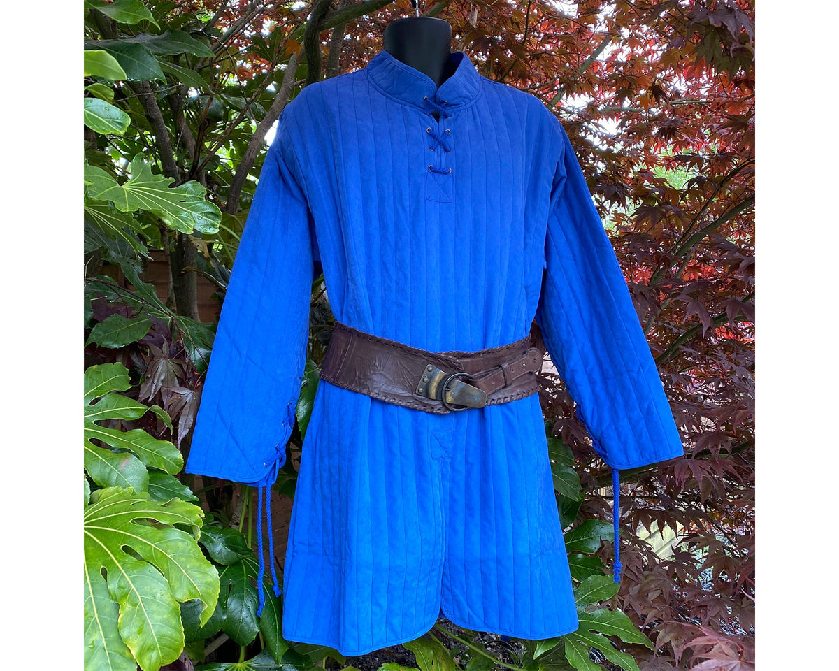 blue cotton Medieval gambeson with a high collar, laced at the chest and wristsbackground, for.