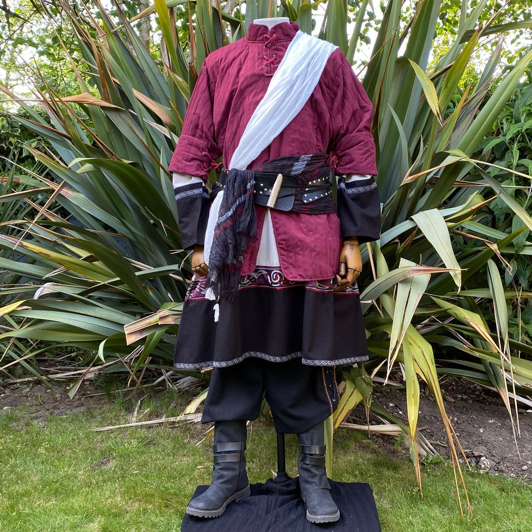 Medieval LARP costume front view, featuring a red gambeson, two-tone tunic, and trousers.