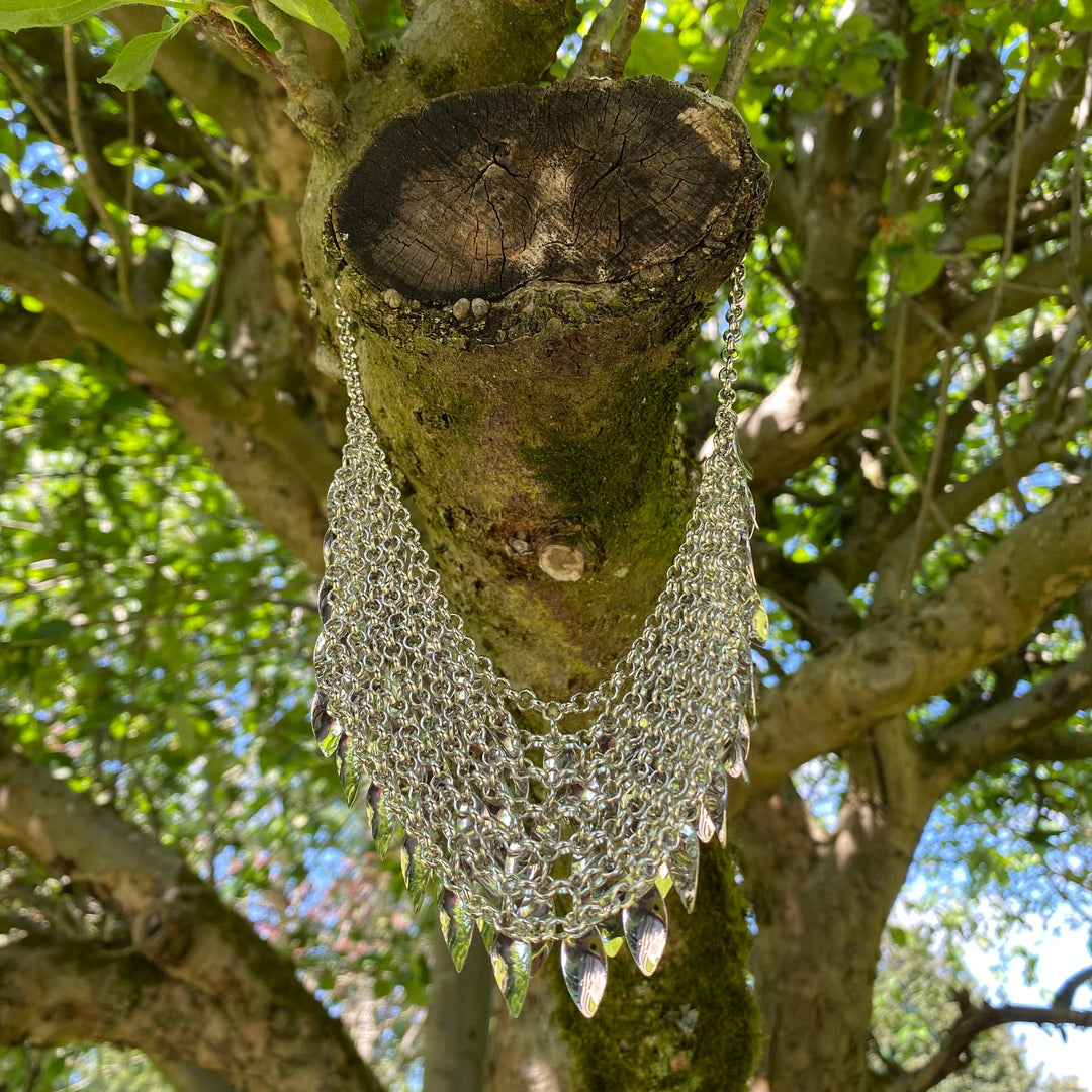 Silver chainmail necklace with leaf charms on tree branch for LARP.