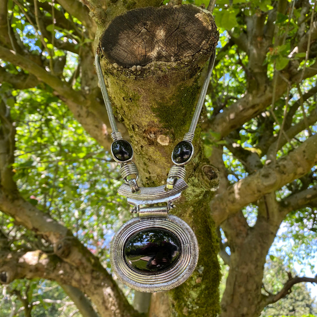 Silver Celtic necklace with black gem in tree for LARP medieval styling.