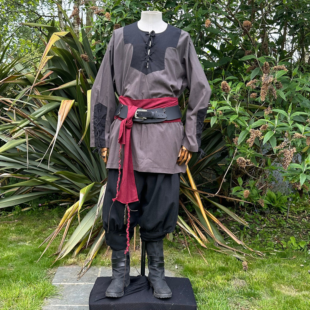 Mannequin in medieval LARP attire with red sash.