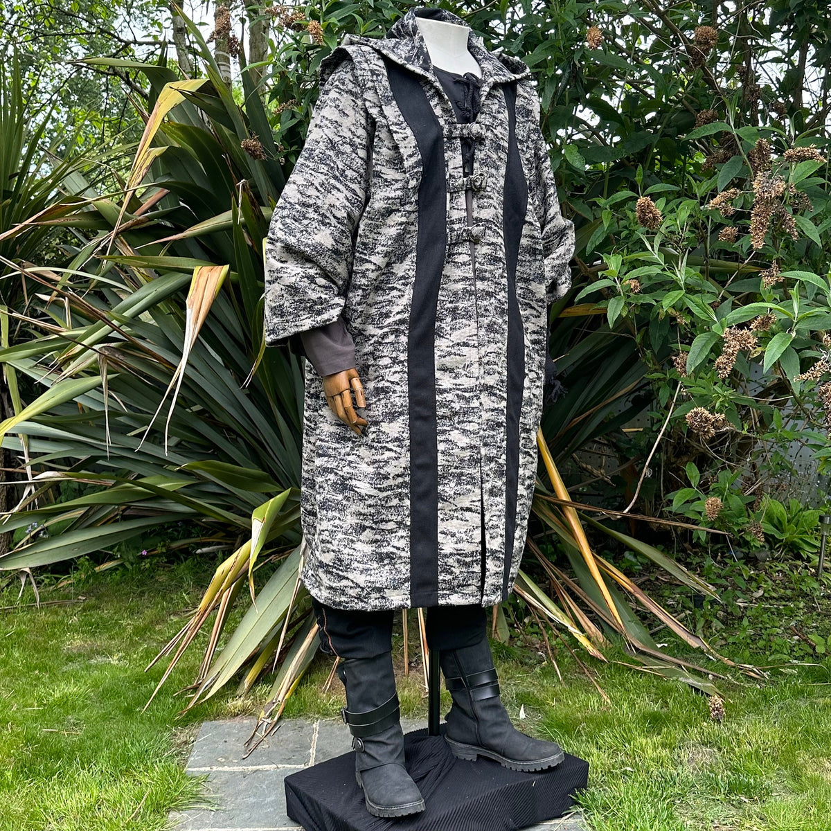 Full-length angled view of beige and black hooded LARP robe, authentic medieval fantasy cosplay.