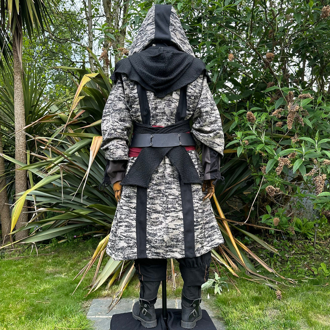 Medieval LARP costume back view, featuring brown and black hooded robe, wool hood, shirt.