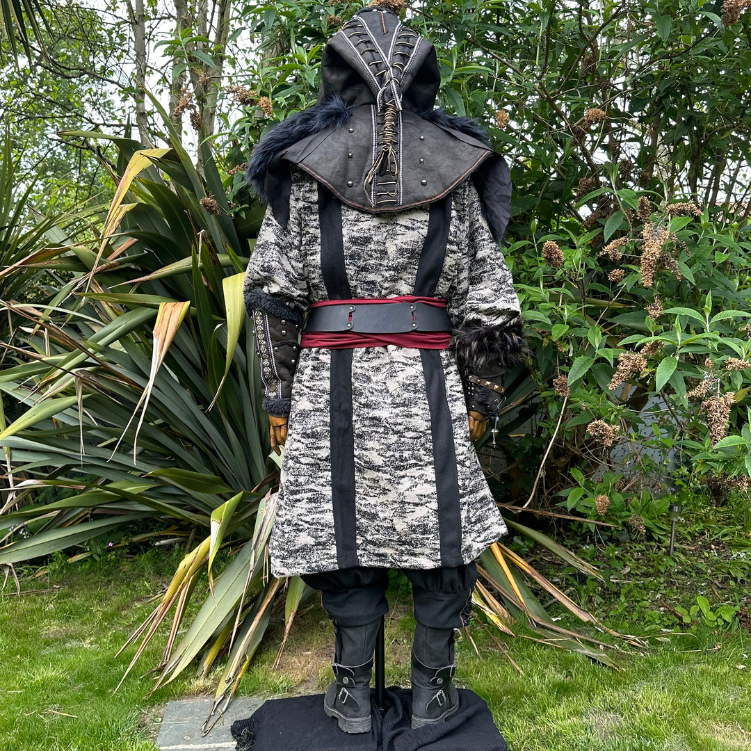 Medieval LARP costume back view, featuring faux leather hood and vambraces, brown hooded robe.