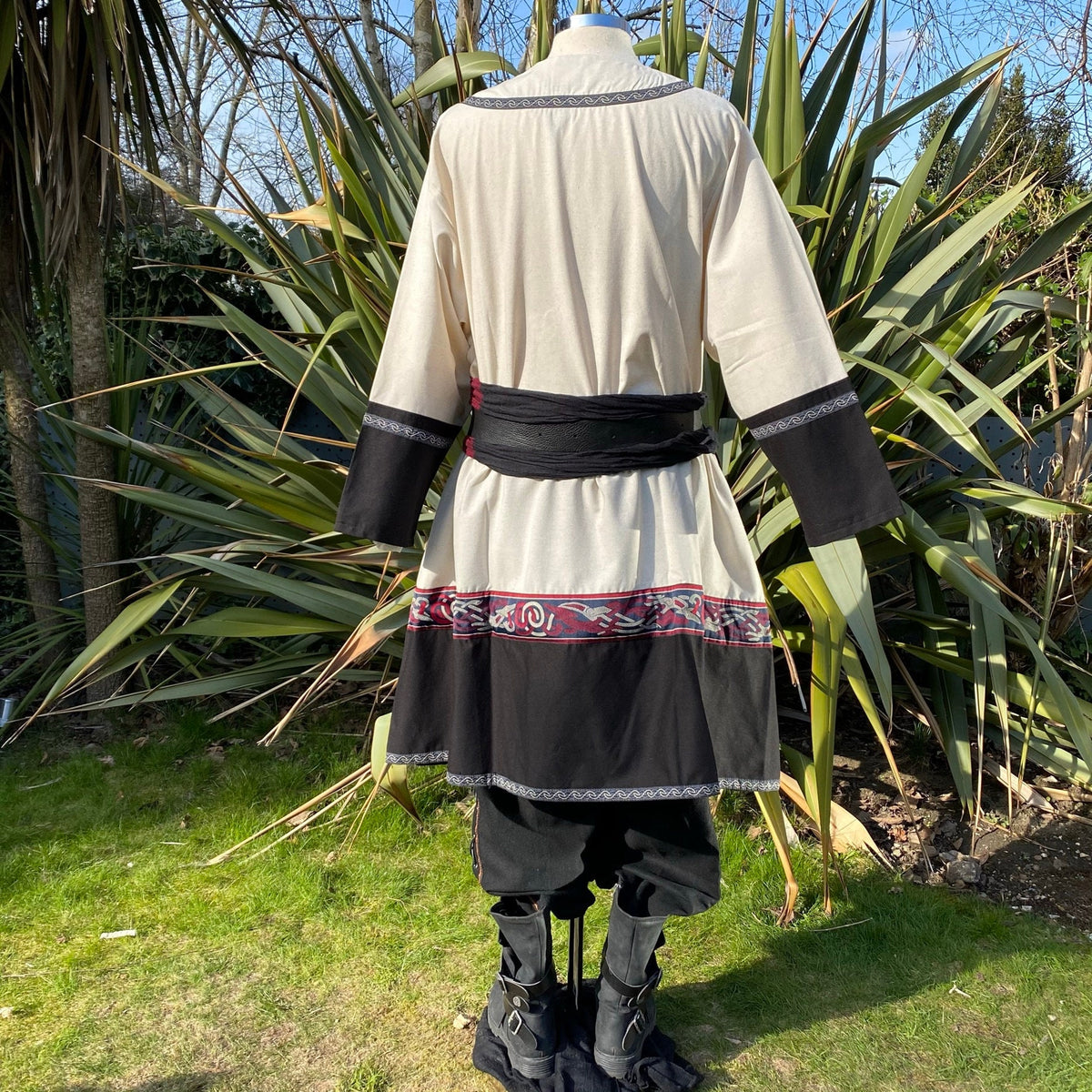 Cream and black medieval gambeson, tunic, trousers set for LARP, rear view.