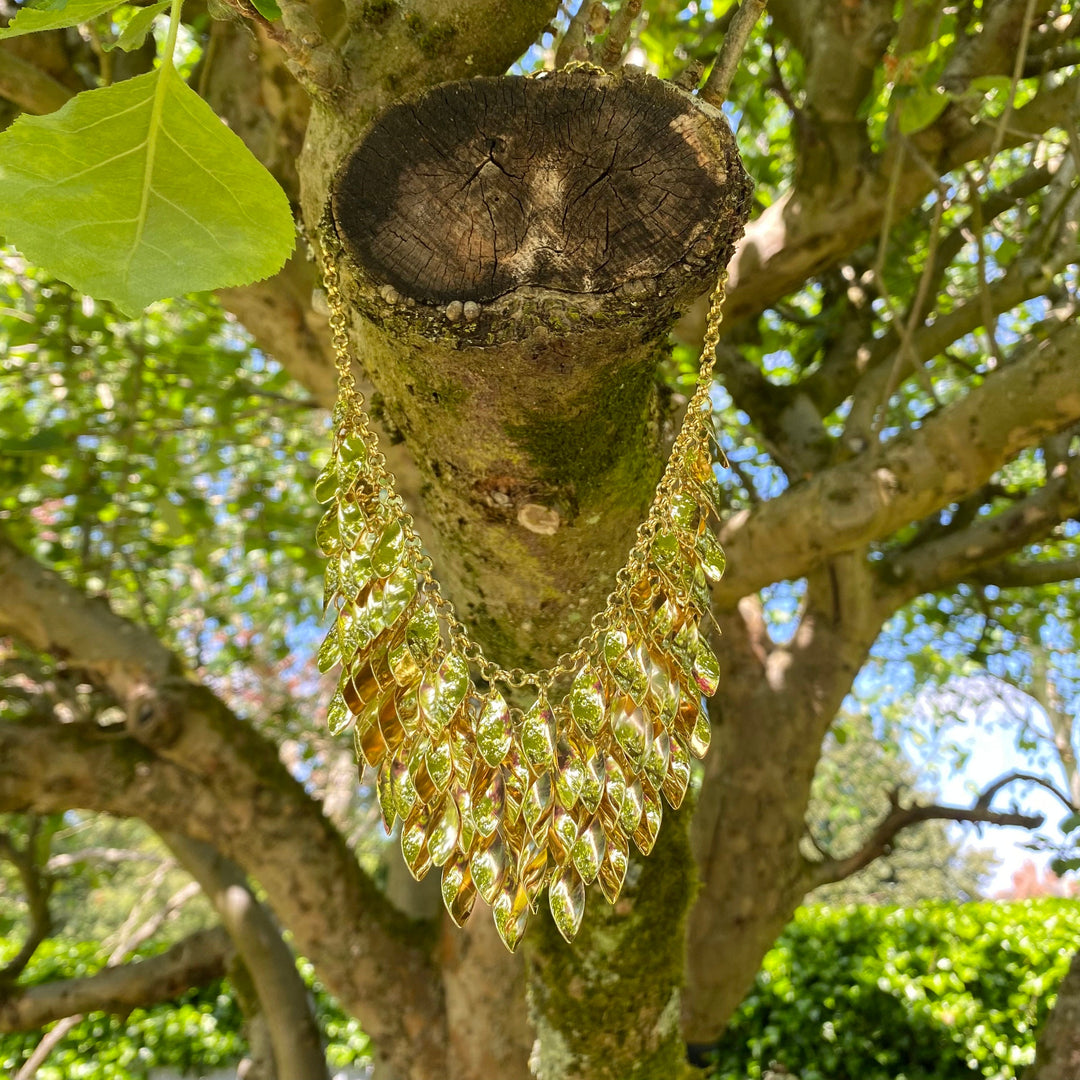 Gold leaf chainmail necklace on tree branch for LARP.
