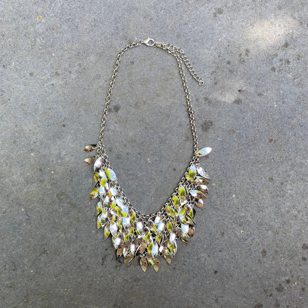 Medieval LARP necklace with six-layered silver leaves on stone backdrop.