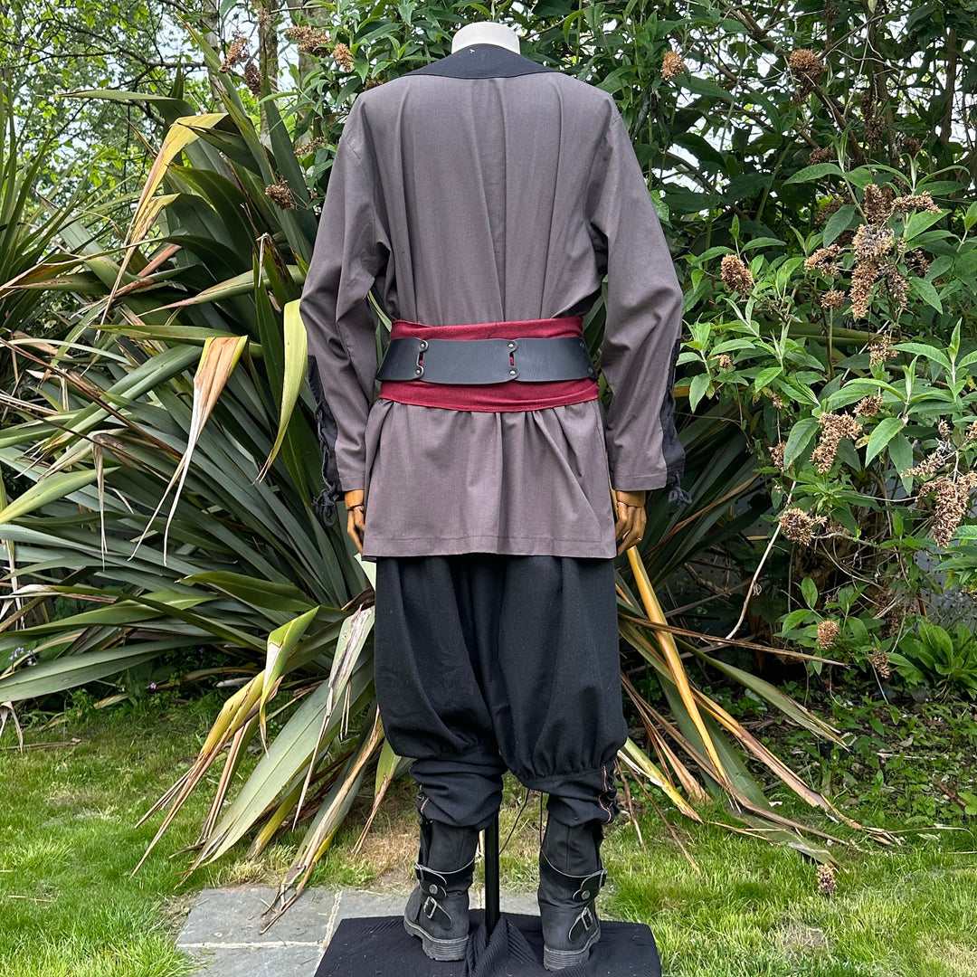 Back view of medieval LARP outfit with red sash.