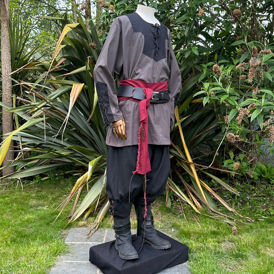 Mannequin in LARP attire with red sash, black boots.