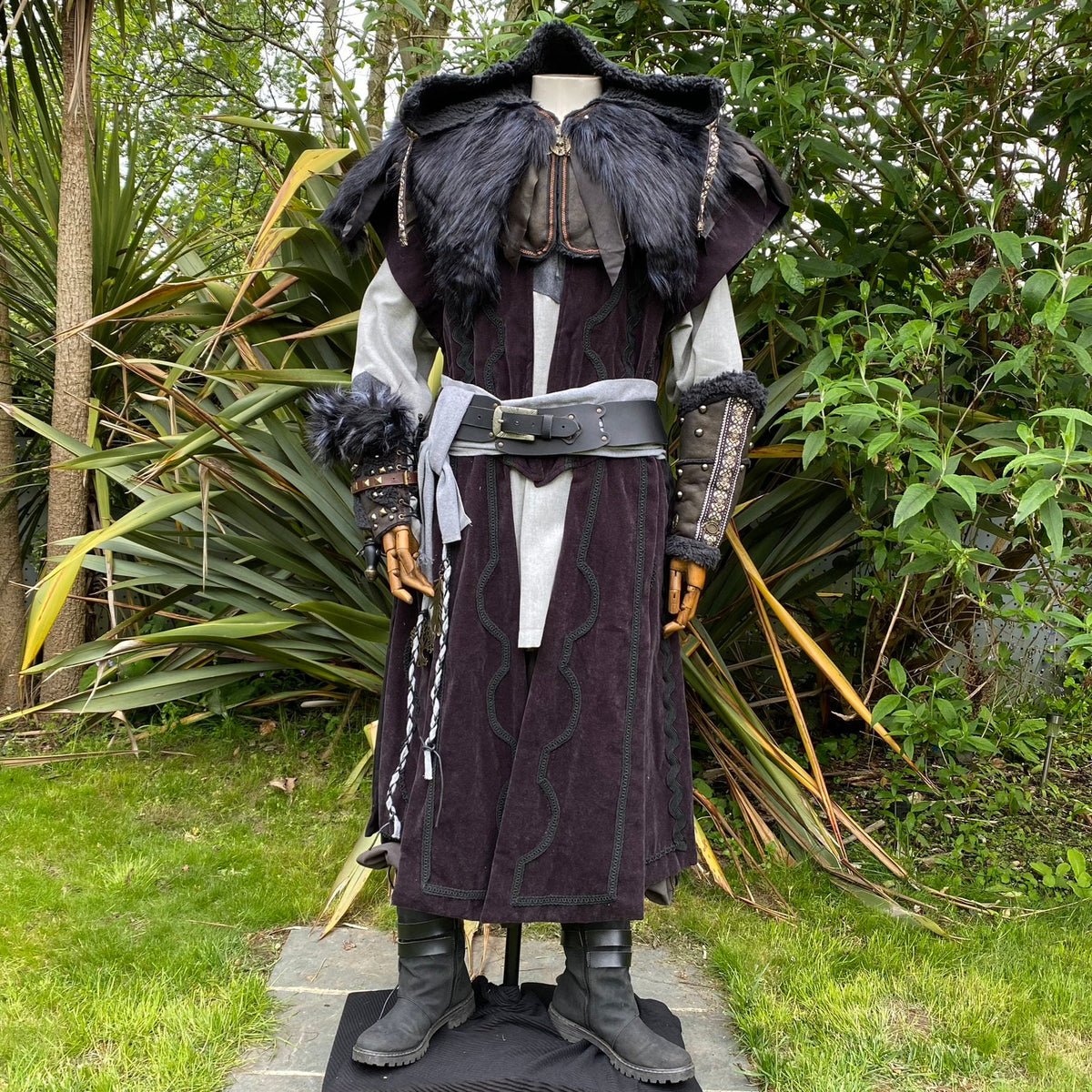 Medieval LARP attire with fur-trimmed hood and grey sash.