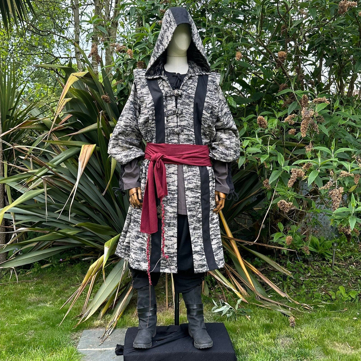 Medieval LARP costume front view, featuring brown and black hooded robe, two-tone shirt.
