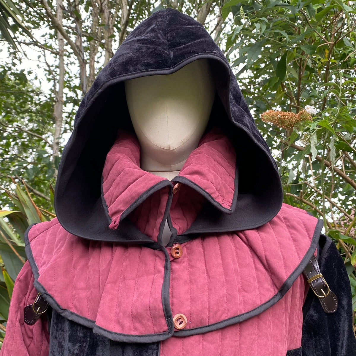 Medieval black hood with red quilted mantle, LARP mannequin.