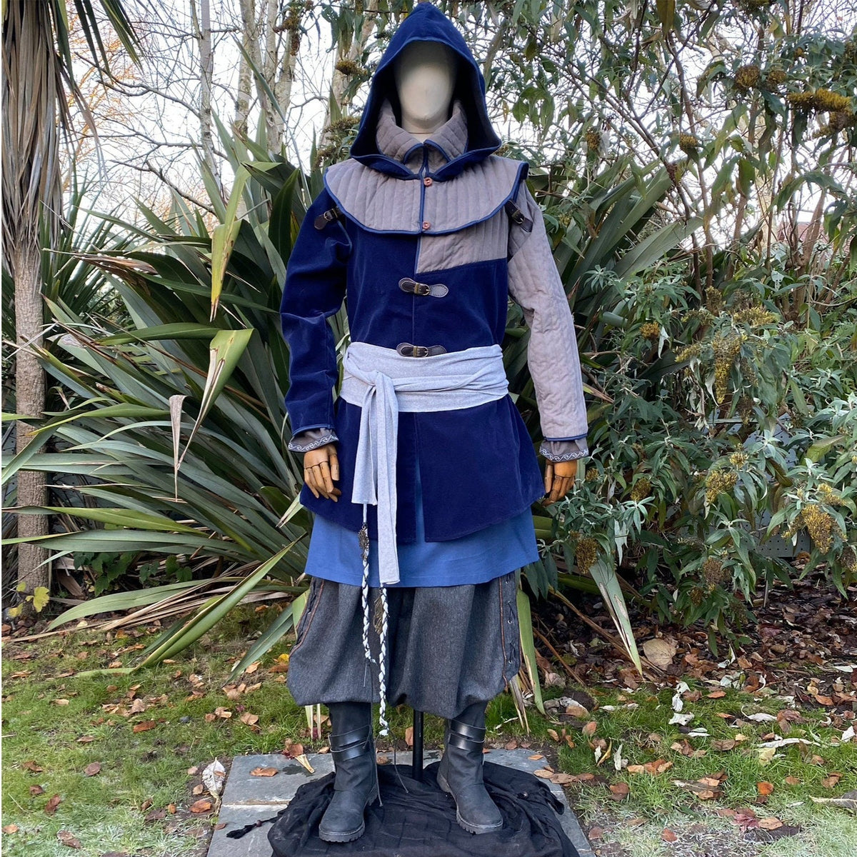 Head-on view of LARP costume with hood, jacket and layered sash.