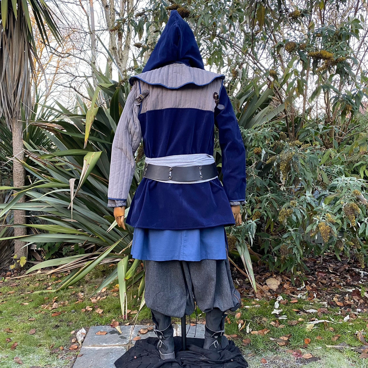 Back view of medieval LARP costume with hood and blue and grey jacket.