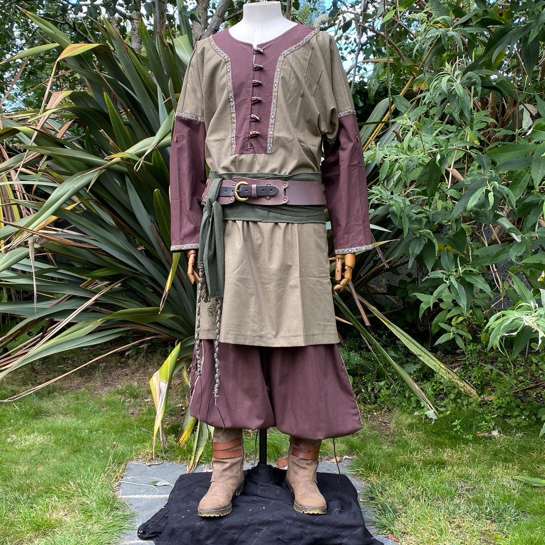 LARP outfit with belt and boots in garden; brown-green medieval tunic detail.