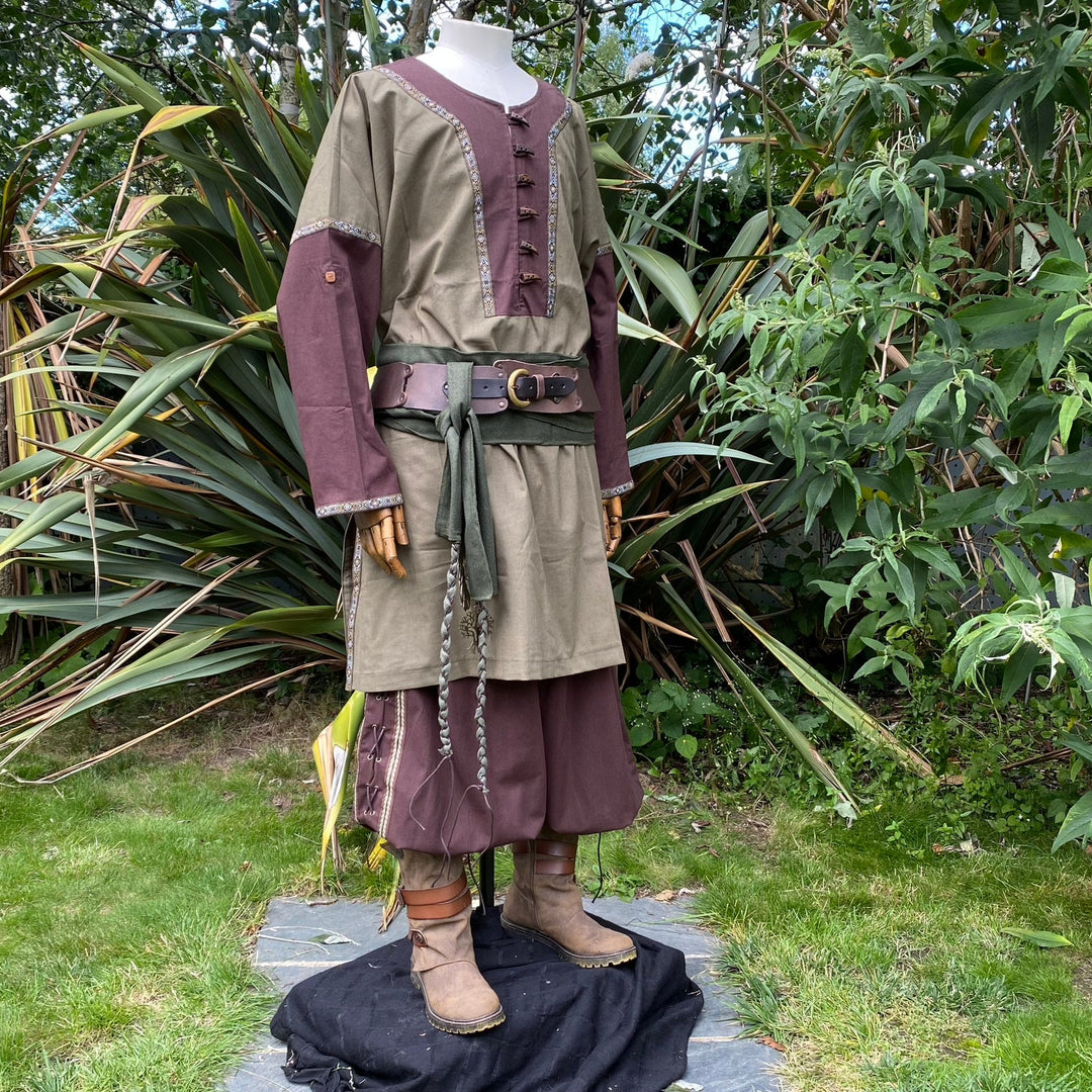 Medieval LARP outfit displayed in garden, tunic with decorative braids.
