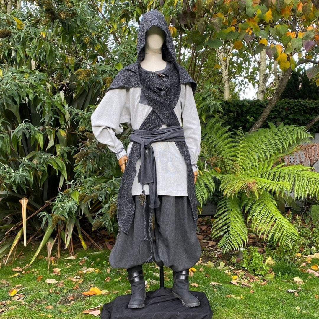 Medieval LARP outfit on mannequin in garden: hooded sash, grey tones, natural backdrop.
