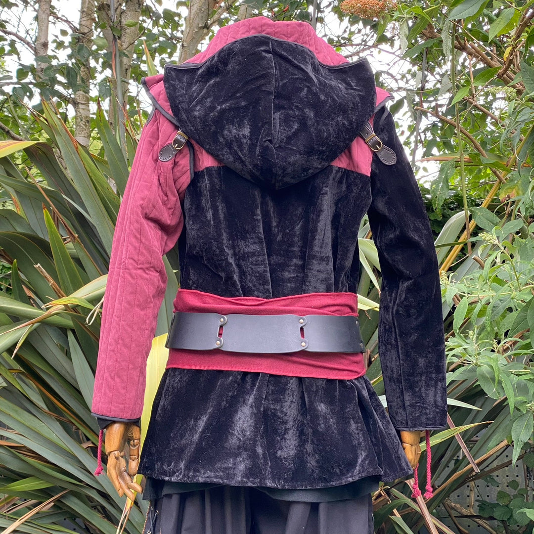 Back view of medieval LARP outfit with black hood and red belt detail.