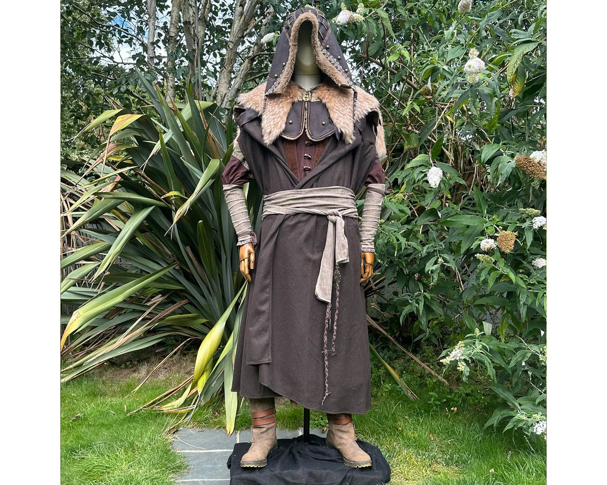 Medieval LARP costume front view featuring brown cloak, faux leather hood, arm wraps and sash.