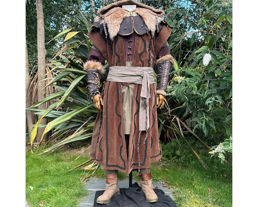 Rustic LARP outfit with hooded cape, detailed vambraces shown.