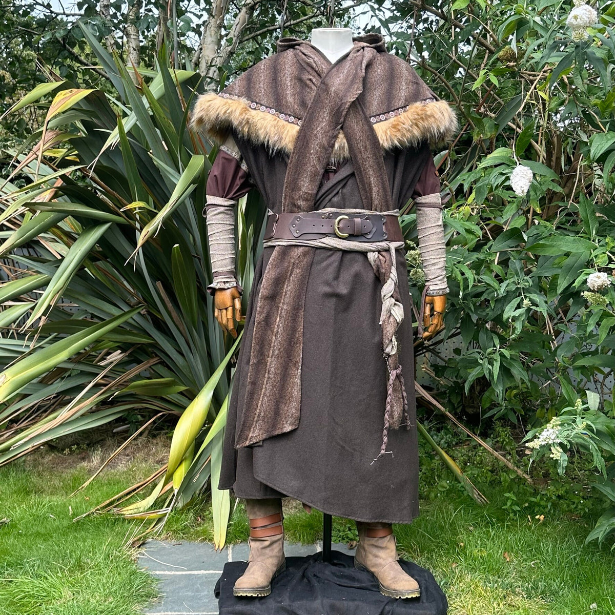Medieval LARP costume side view featuring brown hooded cloak, fur trim hood, arm wraps, leather.